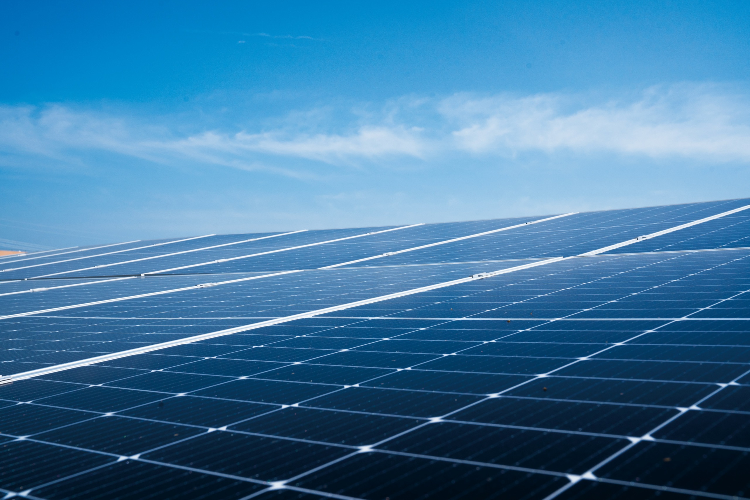 Solar module surface under a wide blue sky